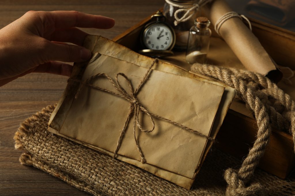 Columbus Day. A pocket watch with a stack of old letters